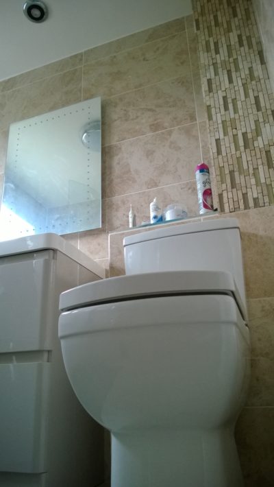bathroom mixed tiling, sink, mirror, toilet